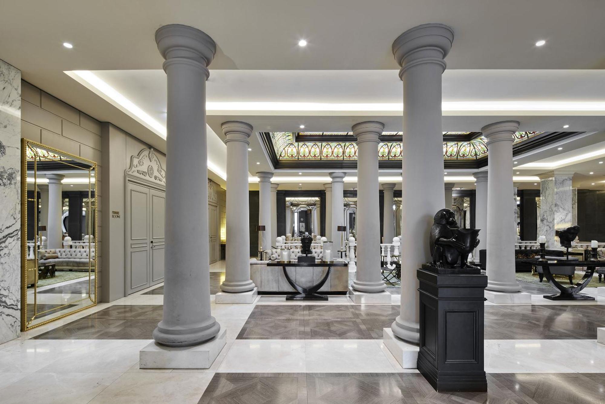 ไททานิค เกนดาร์เมนมาร์ค เบอร์ลิน โฮเทล Hotel ภายนอก รูปภาพ The photo shows an elegant interior space featuring several tall, decorative columns. The flooring is a mix of stone or marble tiles, showcasing a sophisticated design. There are mirrors and other classic architectural details on the walls, contribut